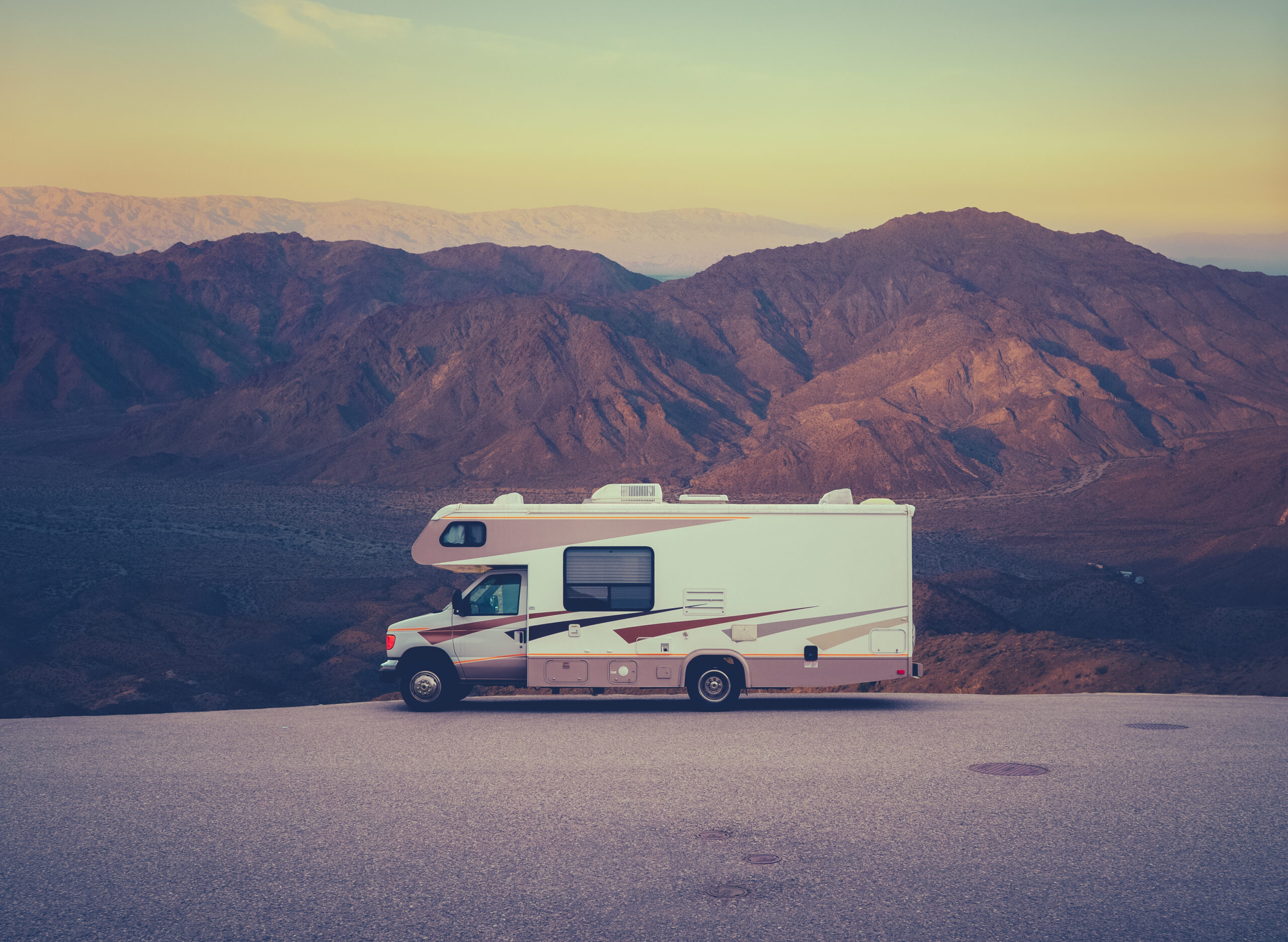 Retro RV Camper In The Californian Desert Wilderness At Sunset